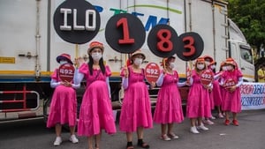 Members of Women's networks dressed as pregnant women and held signs of 'C183' in Bangkok in Thailand