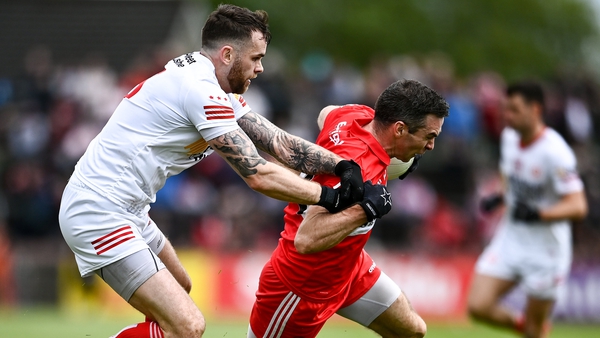 Derry's Benny Heron attempts to get away from Tyrone defender Ronan McNamee
