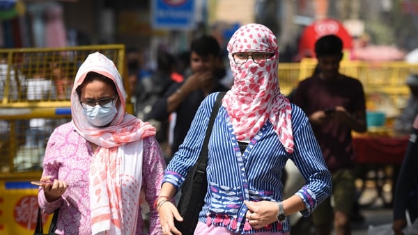 People protect themselves during searing temperatures in New Delhi