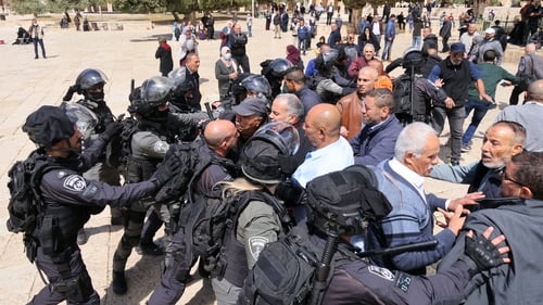 Israeli police restrain Palestinians during clashes today following a visit by a group of Jewish people at the al-Aqsa mosque compound