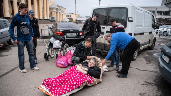 Volunteers from an humanitarian aid centre evacuating Kiseleva Larisa Anatolyevna, who has MS from her flat in Saltivka, Kharkiv
