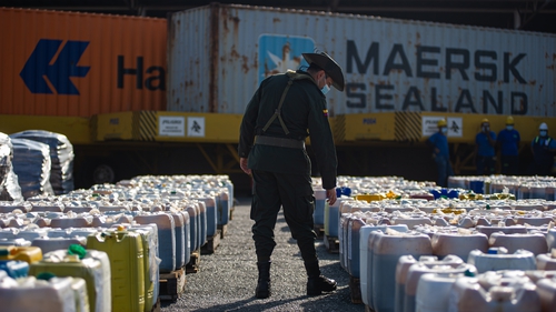 Members of Colombia's anti-narcotics police seize a cargo of molasses mixed with cocaine that was being sent to Valencia in Spain