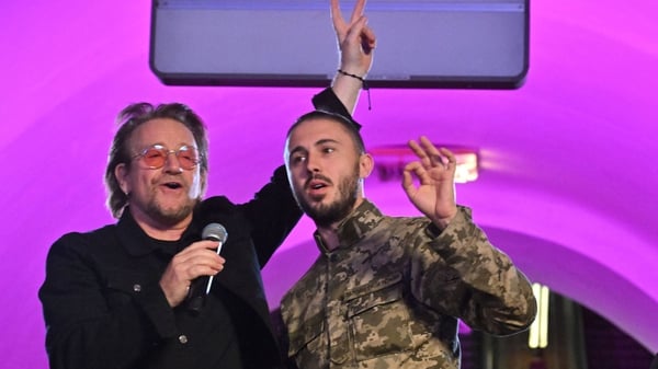 Bono on stage with Ukrainian serviceman Taras Topolia in Kyiv