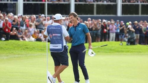 The Dane celebrates with his caddie