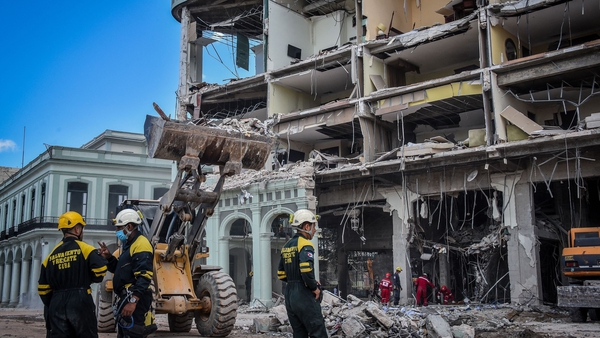 Rescue workers remove debris from the ruins of the Saratoga Hotel in Havana, Cuba, today