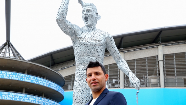 Sergio Aguero (bottom) poses alongside his statue (top)
