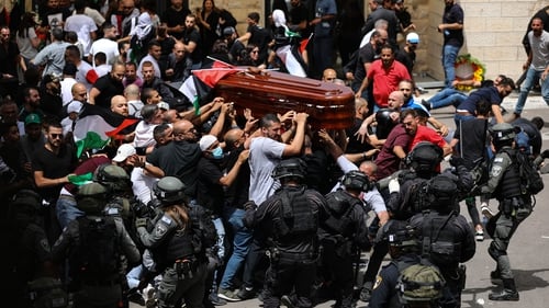 Israeli forces intervene as Palestinians carry the coffin of slain Al-Jazeera journalist Shireen Abu Akleh