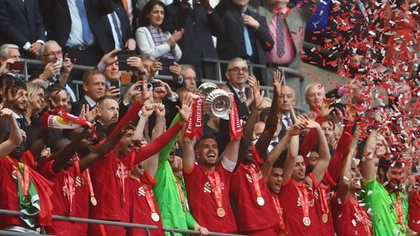 Liverpool captain Jordan Henderson lifts the FA Cup