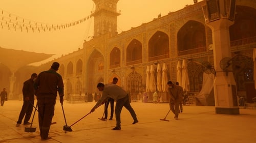Volunteers clean up at the Imam Ali shrine during a sandstorm in Iraq's holy city of Najaf
