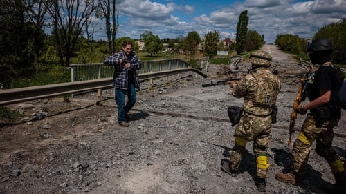 Soldiers of the Kraken Ukrainian special forces unit check a man's documents at Ruska Lozova