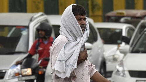 A pedestrian on a hot summer day on 16 May in Noida, India