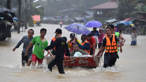 Residents are transported through floodwaters following heavy rains in Ra-ngea district in the southern Thai province of Narathiwat in February