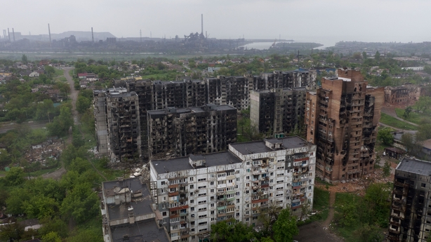 An aerial view of damaged residential buildings and the Azovstal steel plant in the background in Mariupol on 18 May 2022