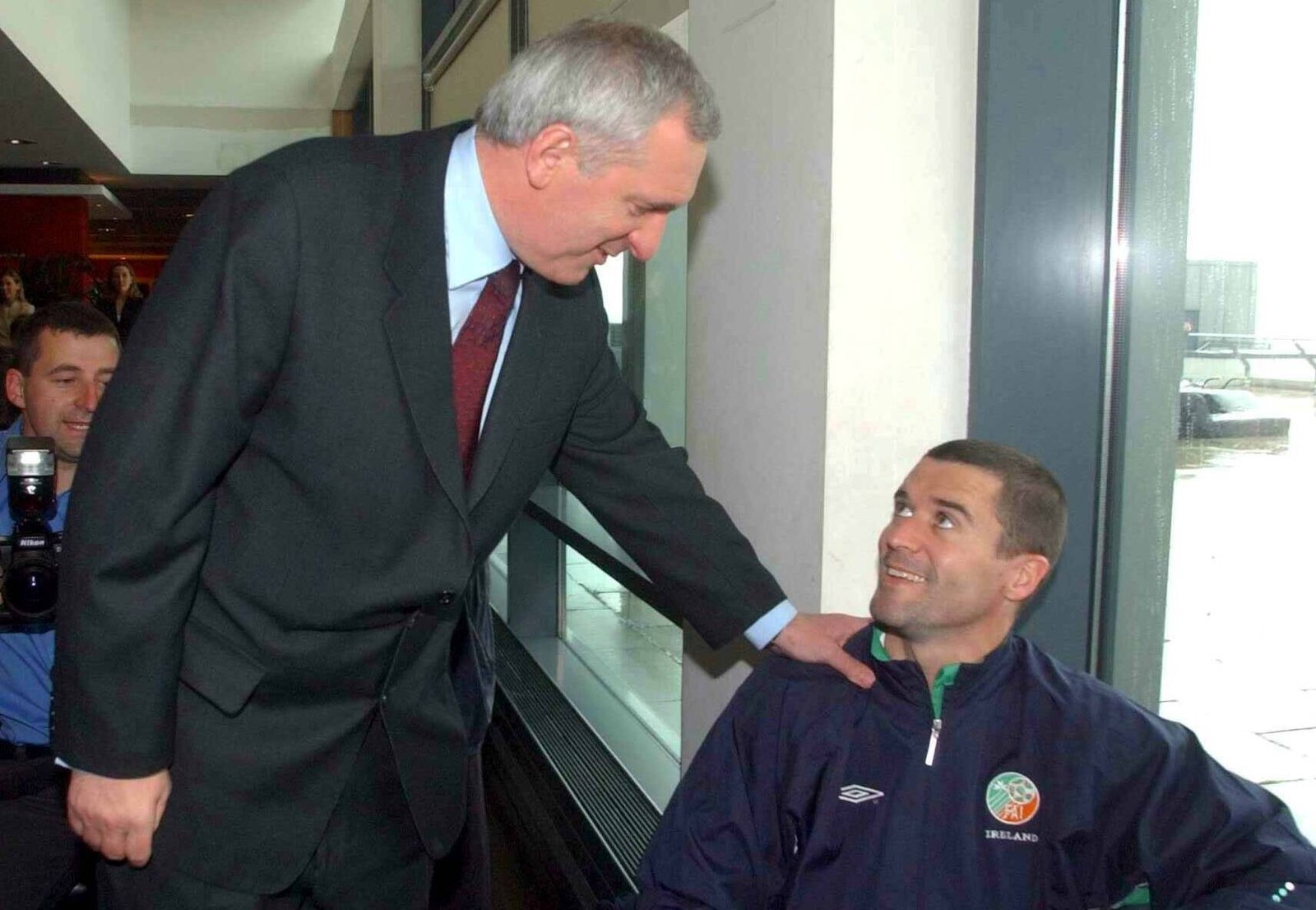 Image - Roy Keane meets Taoiseach Bertie Ahern at Dublin Airport, where there were no seats for the players as they waited to board plane
