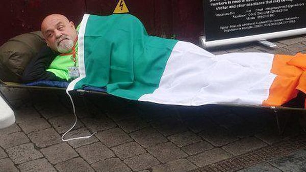 Ex-Defence Forces member Paddy Ward under a tricolour in Galway