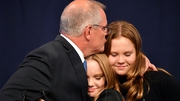 Scott Morrison gives a hug to his daughters Lily and Abbey following the results of the federal election