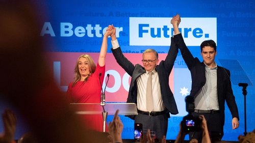 Australian opposition leader Anthony Albanese (C), accompanied by his partner Jodie Haydon and son Nathan Albanese
