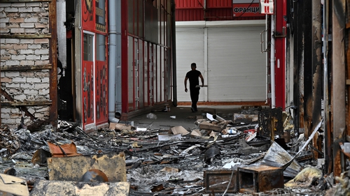 A man walks at one of Europe's largest clothing markets, which was destroyed by shelling in Kharkiv on 21 May