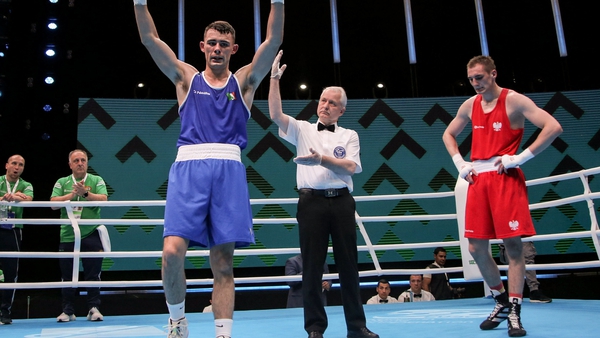 Luke Maguire raises his hands in victory following his bout with Poland's Daniel Wieslaw Piotrowski