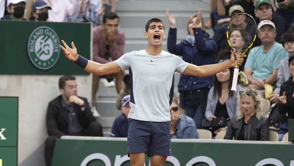 Carlos Alcaraz celebrates his victory after a deciding set at Roland Garros