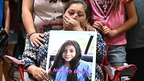 Grandmother Esmerralda Bravo holds a picture of her ten-year-old grandaughter Naveah who was a victim in the shooting
