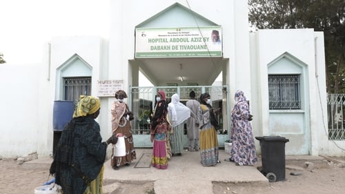 Visitors stand in front of the Mame Abdoul Aziz Sy Dabakh Hospital where the babies died