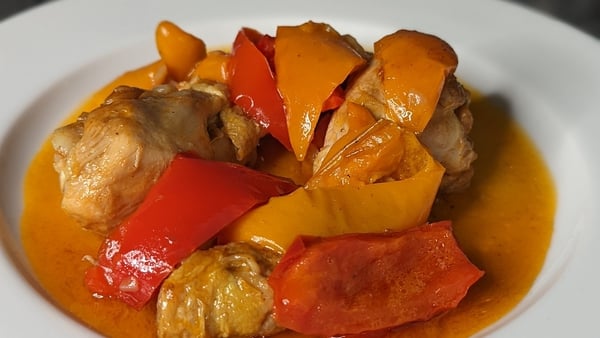 Traditional Roman style braised chicken, with roasted red and yellow bell peppers.