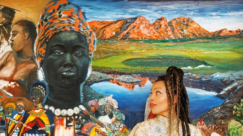 Emma Dabiri, Irish Nigerian broadcaster, historian and bestselling author stands at an artwork by Irish Congolese artist Ajao Lawal. Dabiri launched the new exhibition Revolutionary Routes: Ireland & The Black Atlantic at EPIC The Irish Emigration Museum.