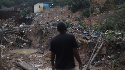 A man looks at the site of a landslide in the community Jardim Montes Verdes in Recife