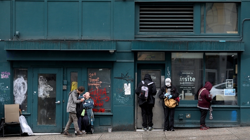 Clients wait outside Insite, a supervised consumption site in Vancouver where clients inject illicit drugs under the supervision of nurses