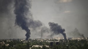 Smoke rises in the city of Sievierodonetsk during heavy fighting on 30 May