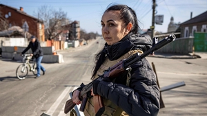 A volunteer takes position at a checkpoint in a district in Kyiv, on 20 March