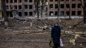 A woman at a destroyed building after a Russian missile attack in Vasylkiv, near Kyiv, on 27 February