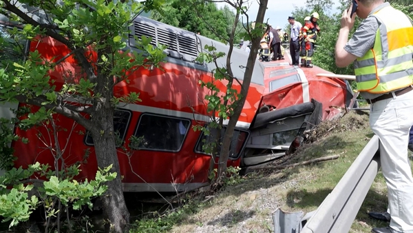 Firemen work around a derailed trail in Burgrain in southern Germany