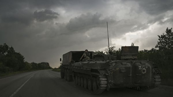An armoured vehicle is towed near the city of Soledar in the eastern Ukrainian region of Donbas today