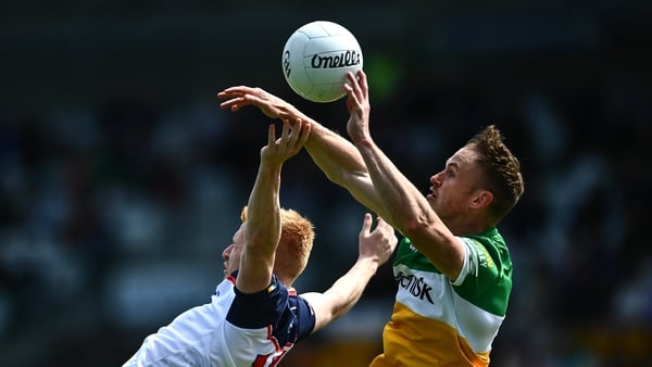 New York's Adrian Varley competes with Offaly's Declan Hogan in Tullamore