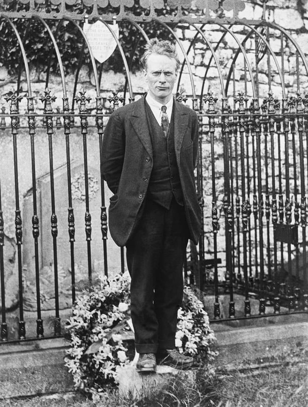 Liam Mellowes standing in front of Wolfe Tone's grave
