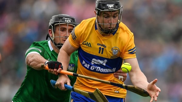 Limerick's Darragh O'Donovan tries to tackle Clare's Tony Kelly