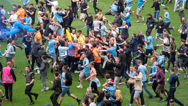 Manchester City fans ran on to the pitch after they won the Premier League
