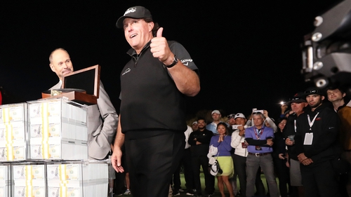 Phil Mickelson poses with his $9m in prize money after defeating Tiger Woods in The Match in 2018