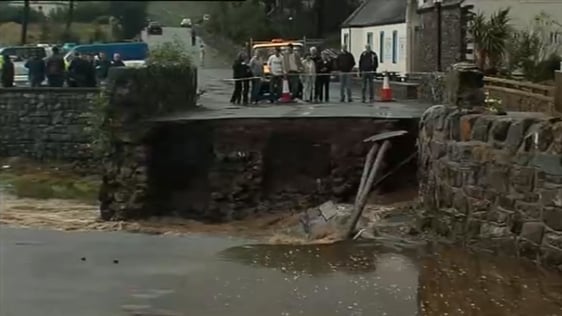 Locals observe the collapsed bridge in Leenane, County Galway, 2007.