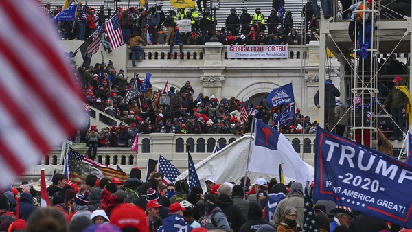 Trump supporters take over the Inaugural stage during the 6 January attack on the US Capitol