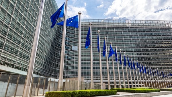 EU flags on flying on front of the European Commission headquarters in Brussels
