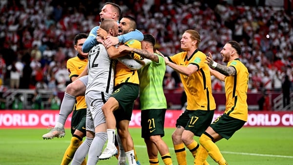 Andrew Redmayne is mobbed by his Australia team-mates after saving the decisive spot-kick