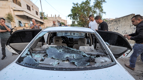 Locals inspect the car where the men were killed in Jenin