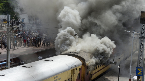 Protesters set a train on fire during a demonstration in Secunderabad