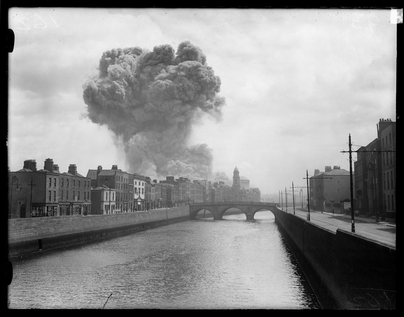 Image - The massive mushroom cloud generated by the detonation of mines and explosives at the height of the assault (Credit: RTÉ Cashman Collection)