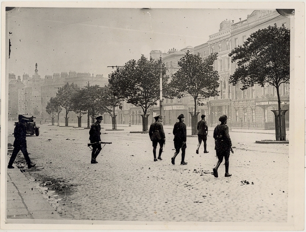 National Army soldiers walking cautiously across O Connell Street during a lull in the fighting Photo: OPW/Kilmainham Gaol Archives 20PO-1A34-18