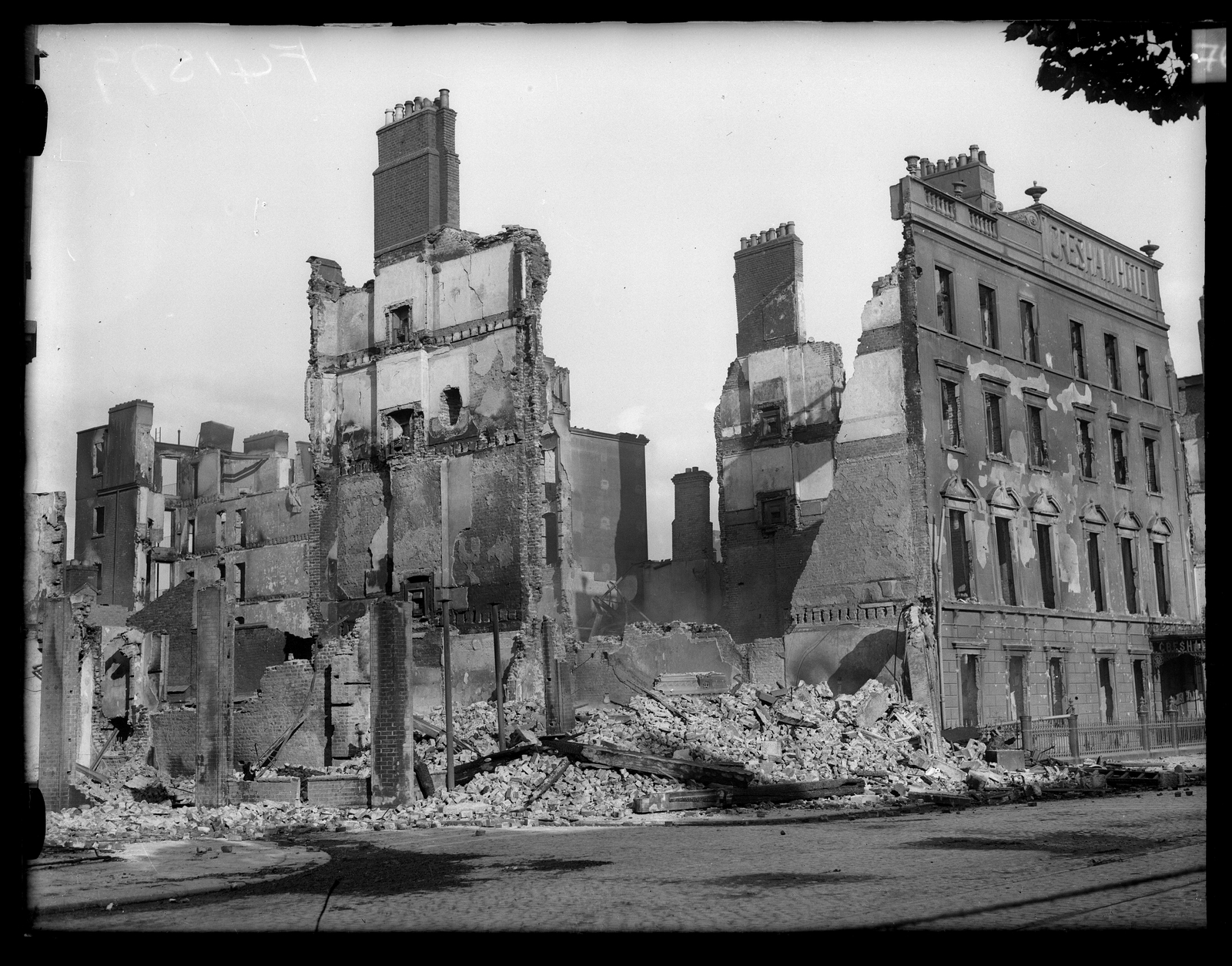 Image - ... And the same street block in ruins, a few days later (Credit: RTÉ Photographic Archive, the Cashman Collection)