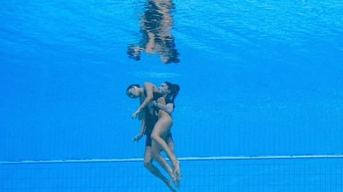 Andrea Fuente swims to the surface with Anita Alvarez